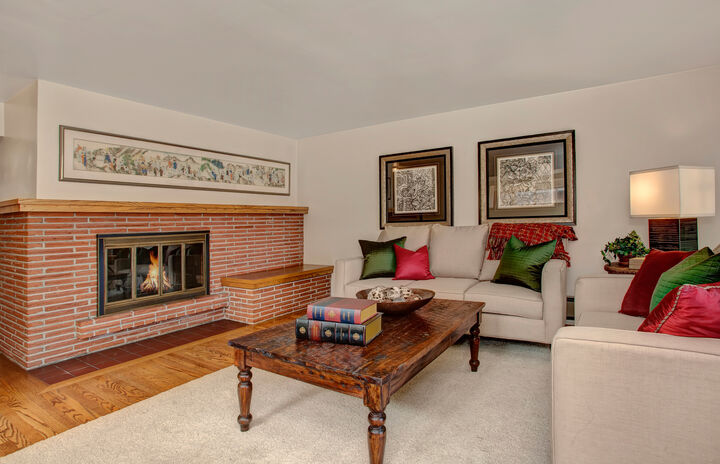 Property Photo: Spacious living room with fireplace and hardwood floors 1859 40th Avenue E  WA 98112 