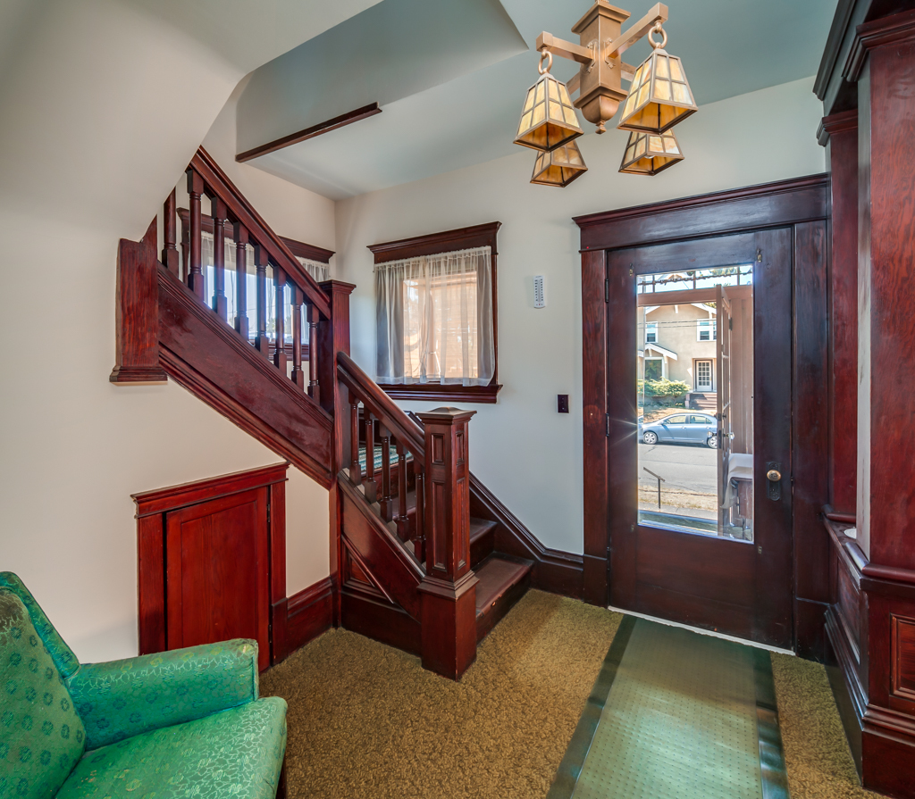 Property Photo: The entry is grand, and there are fir floors under the carpet. notice the original woodwork and the grand stairway...not to mention the original light fixture! 1900 G St  WA 98225 